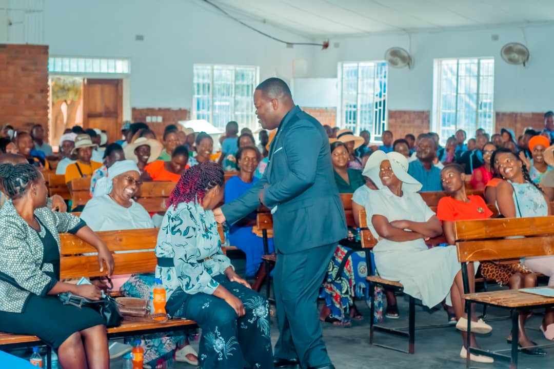 MFM Academy — Speaker greeting families in the hall