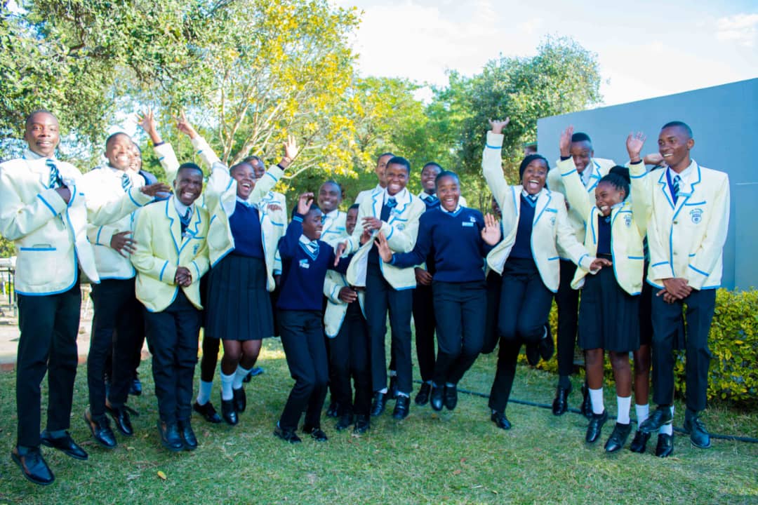MFM Academy students celebrating in their academic dress